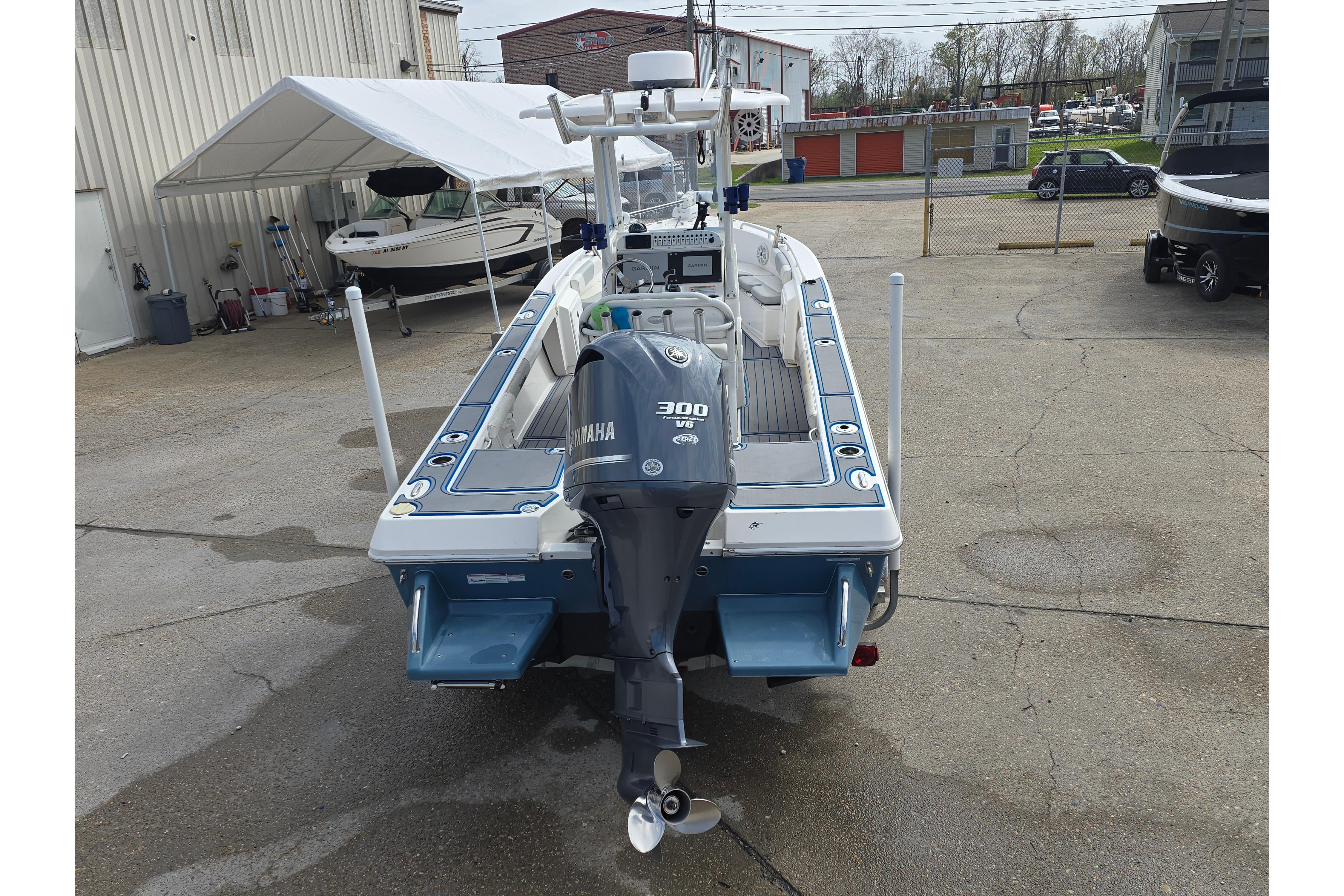 2012 Everglades 243 Center Console boat with Yamaha 300 engine, parked outdoors.