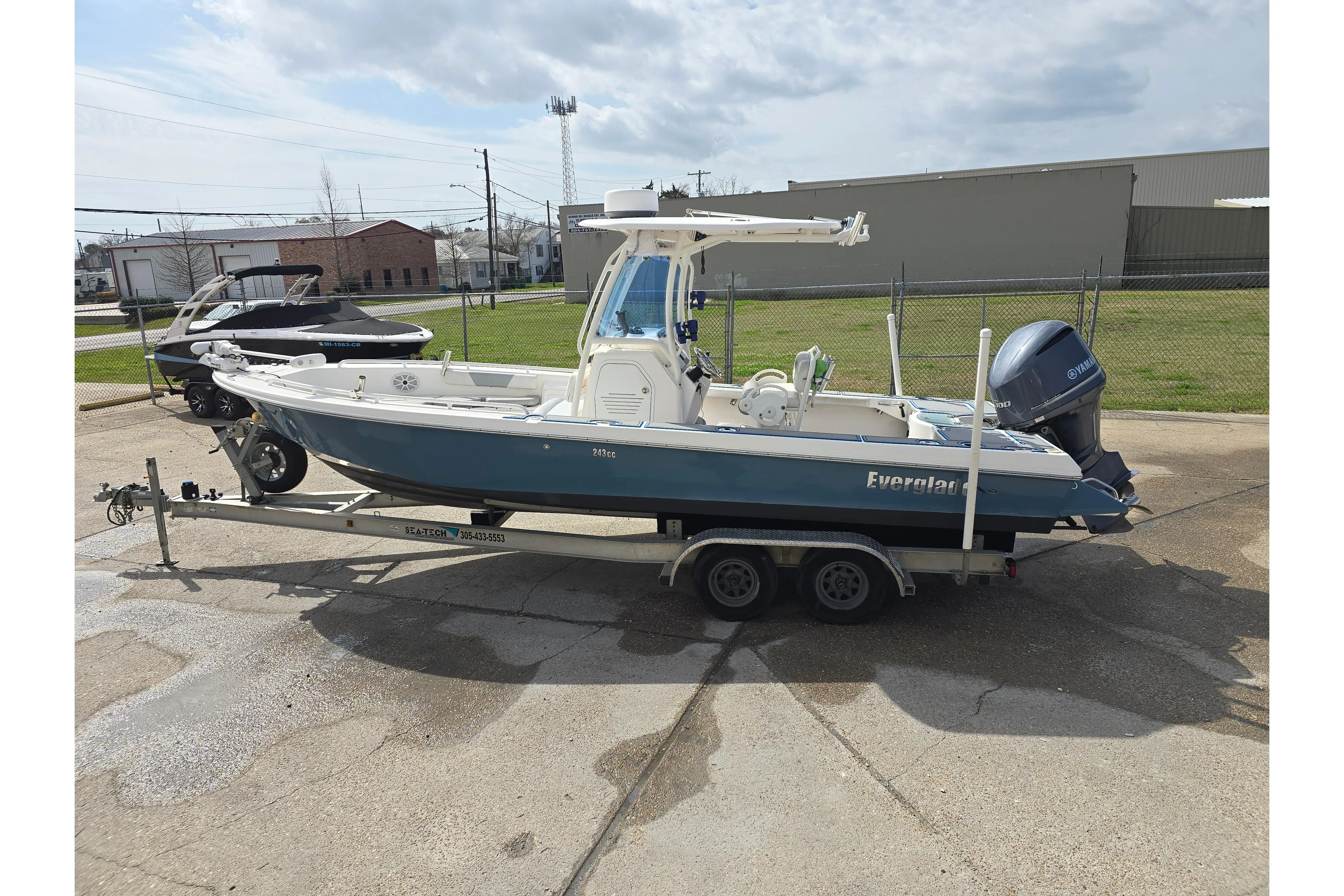 2012 Everglades 243 Center Console boat on trailer, parked outdoors.