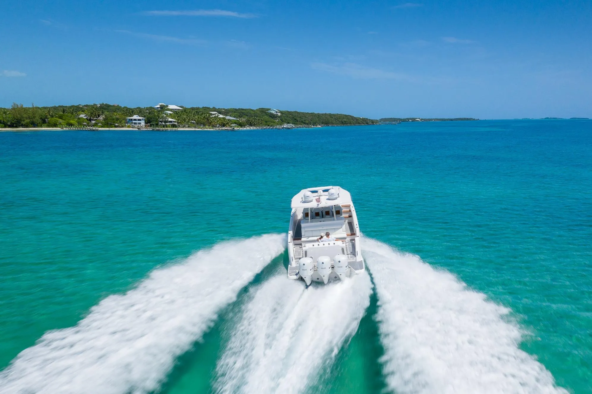 2026 Regal 38 SAV cruising on clear turquoise waters under a bright blue sky.