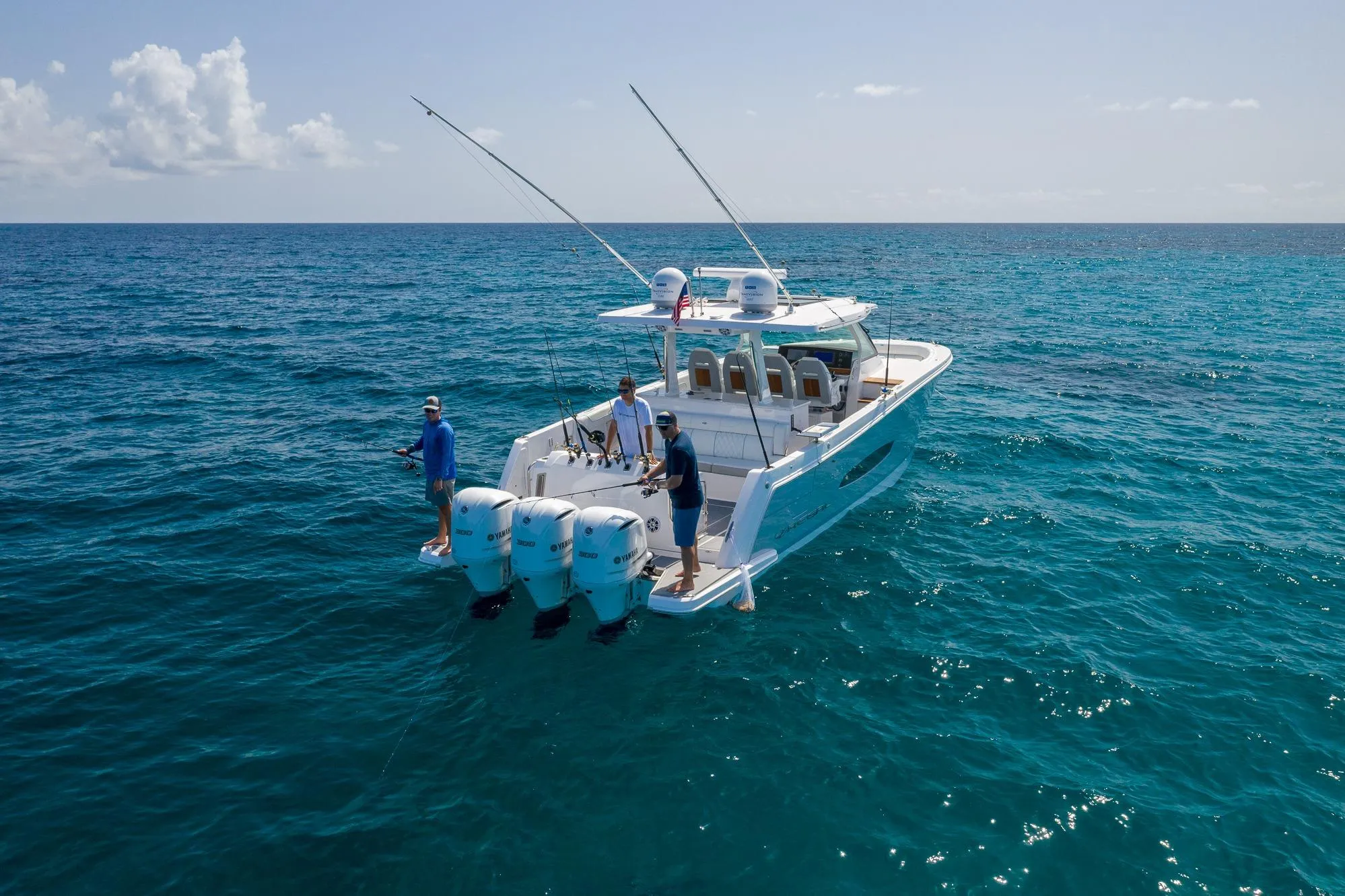 2026 Regal 38 SAV boat on open sea with fishing enthusiasts onboard.