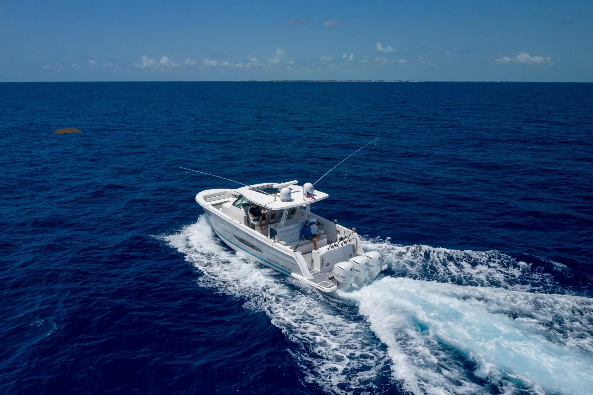 2026 Regal 38 SAV boat cruising on open ocean under clear blue sky.