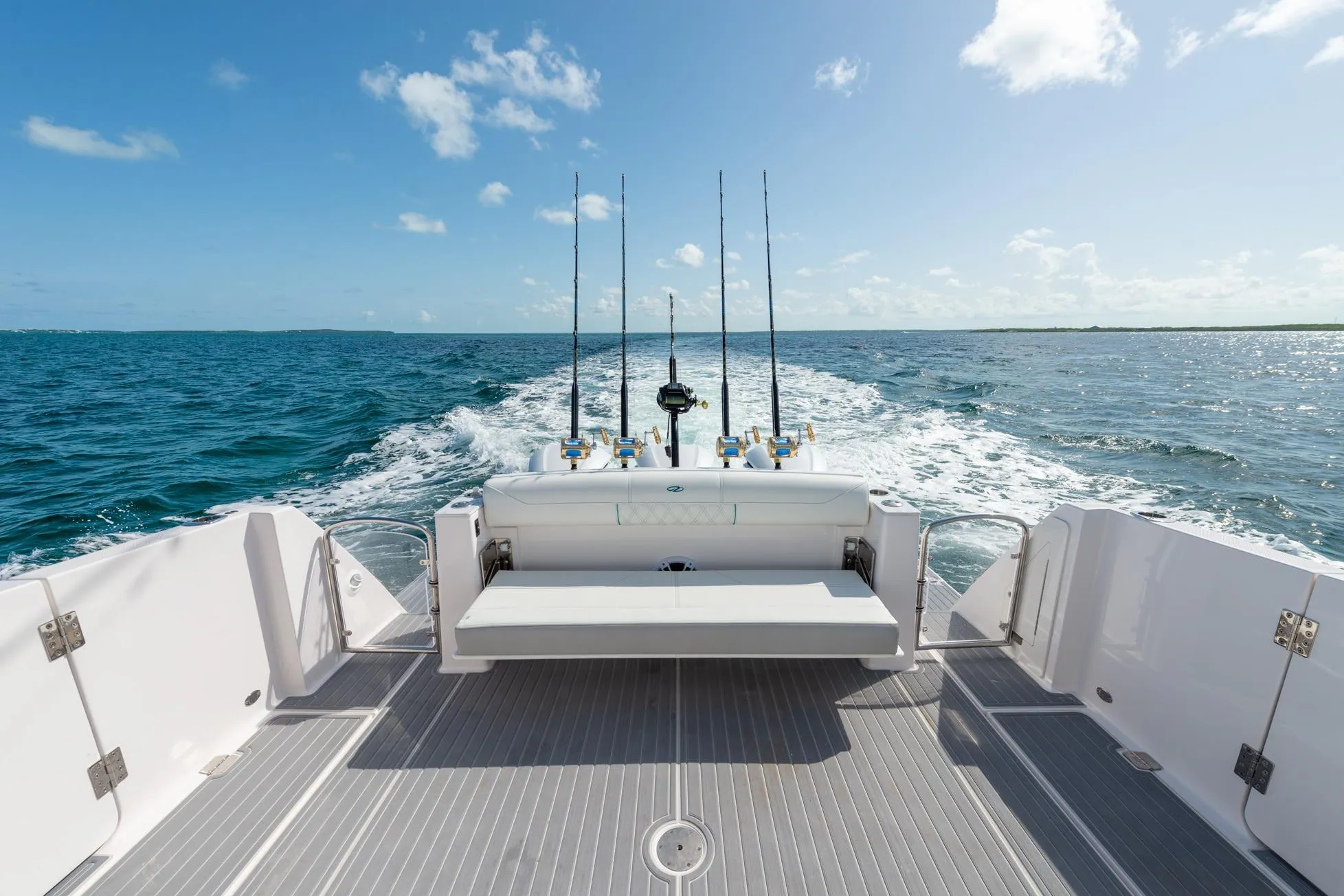 2026 Regal 38 SAV boat cruising on open water, featuring fishing rods and a spacious deck.