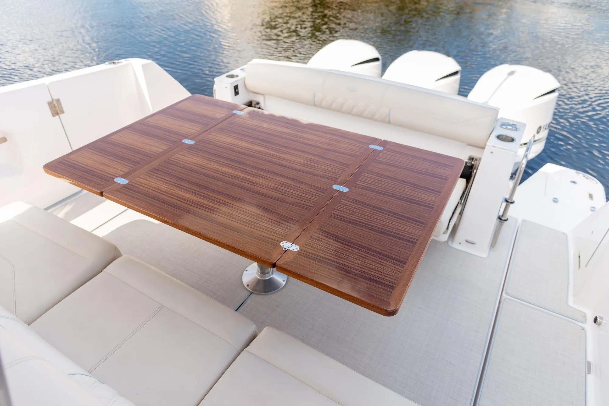 Luxurious 2026 Regal 38 SAV boat interior with elegant wooden table and comfortable seating.