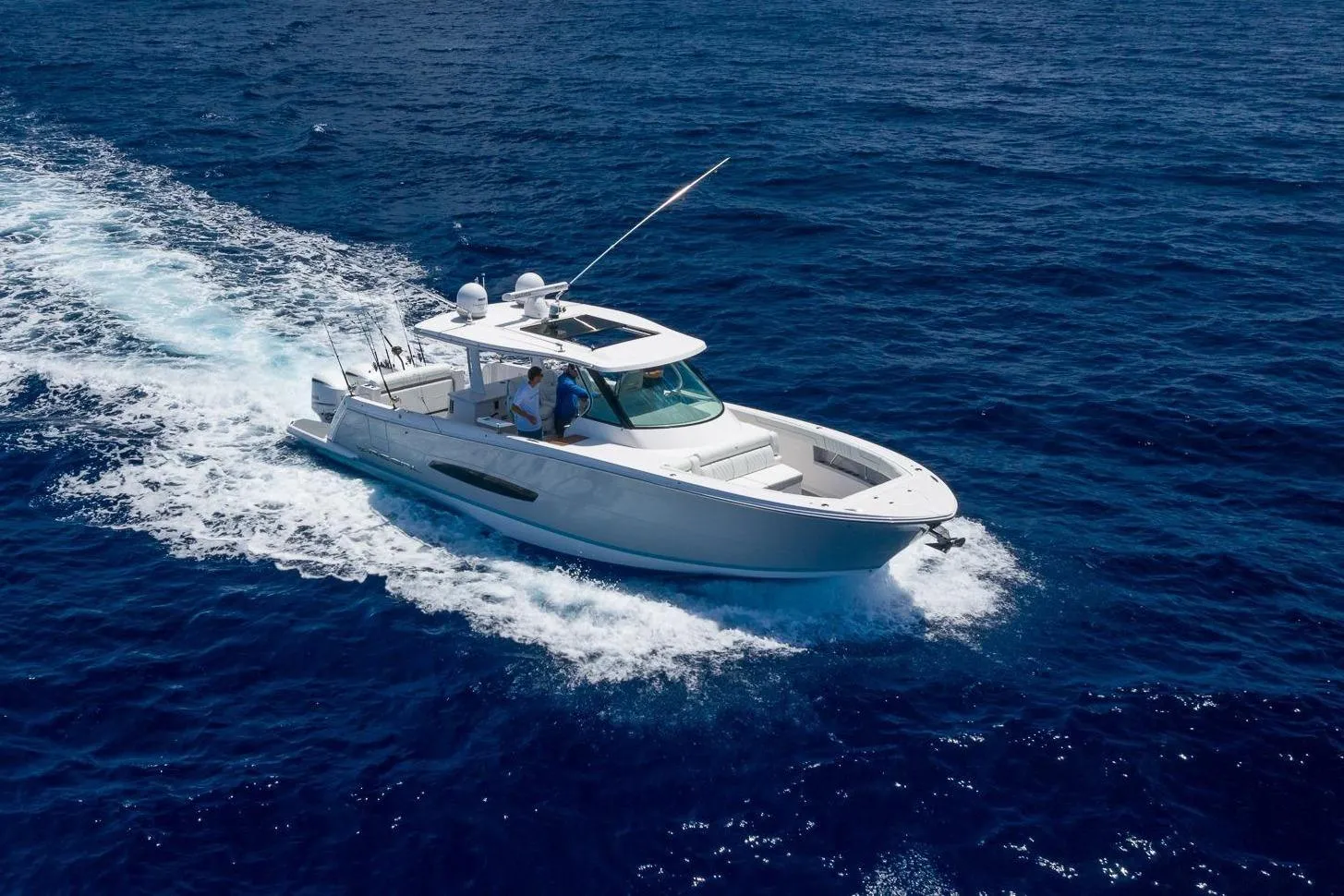 2026 Regal 38 SAV cruising on open ocean under clear blue sky.