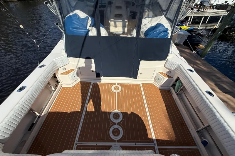  Yacht Photos Pics 2005 Grady-White Express 330 boat deck with wood flooring and cushioned seating.