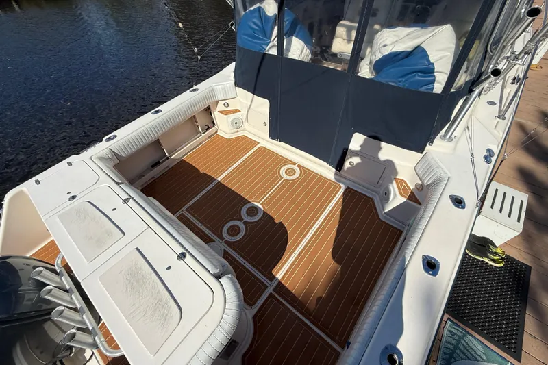  Yacht Photos Pics 2005 Grady-White Express 330 boat deck with wood finish and seating area.