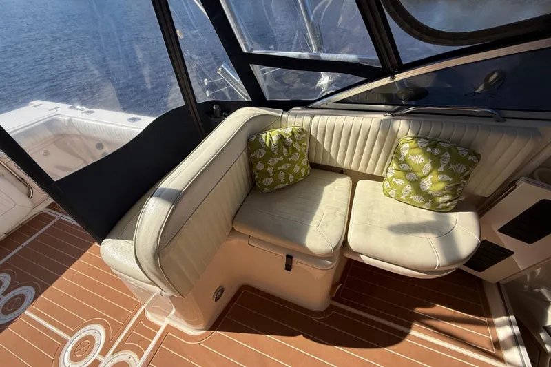  Yacht Photos Pics 2005 Grady-White Express 330 boat interior with cushioned seating and decorative pillows.
