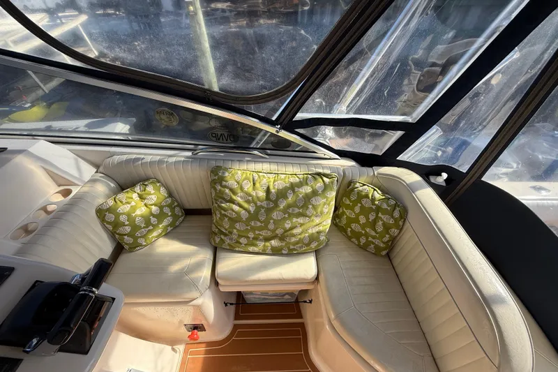  Yacht Photos Pics Interior of 2005 Grady-White Express 330 boat with cushioned seating and decorative pillows.