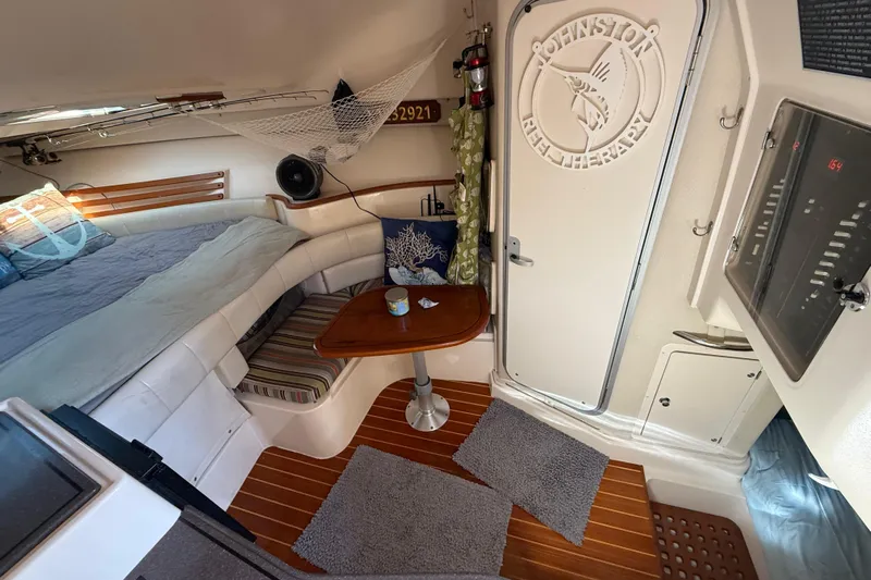  Yacht Photos Pics 2005 Grady-White Express 330 cabin interior with cozy seating and wooden table.