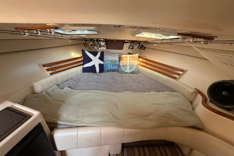  Yacht Photos Pics Cozy cabin interior of 2005 Grady-White Express 330 with comfortable bedding and nautical decor.