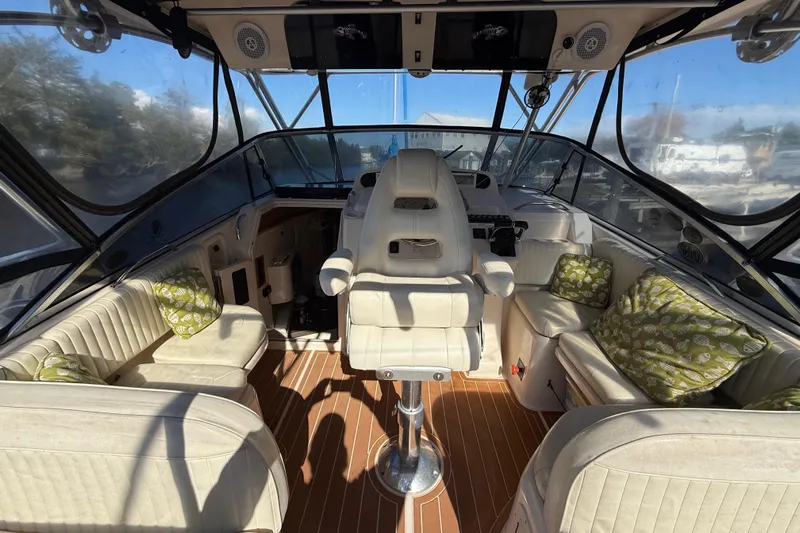  Yacht Photos Pics 2005 Grady-White Express 330 boat interior with cushioned seating and helm.