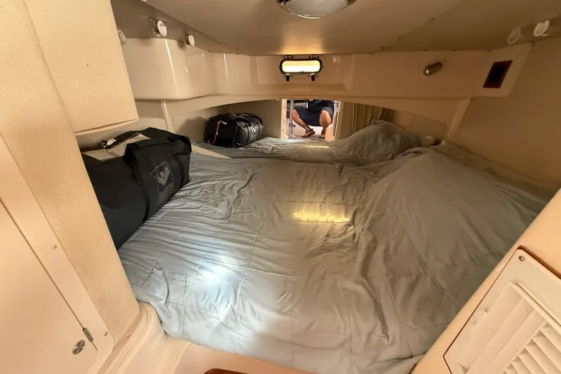  Yacht Photos Pics Interior cabin of 2005 Grady-White Express 330 with bed and luggage.