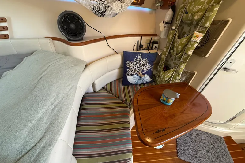  Yacht Photos Pics 2005 Grady-White Express 330 cabin interior with cozy seating and wooden table.