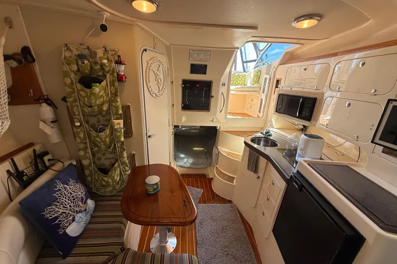  Yacht Photos Pics Interior of 2005 Grady-White Express 330 boat with kitchenette and seating area.