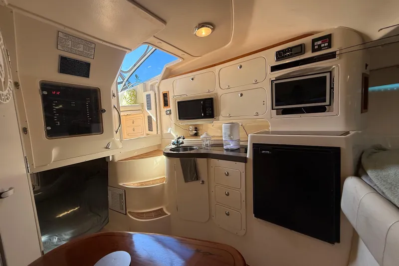  Yacht Photos Pics 2005 Grady-White Express 330 cabin interior with kitchenette, microwave, and storage cabinets.
