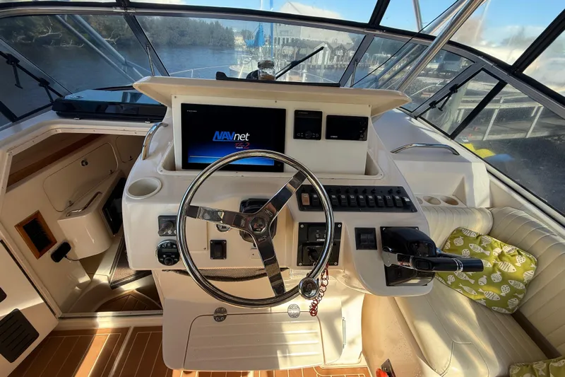  Yacht Photos Pics 2005 Grady-White Express 330 helm with steering wheel and navigation system.