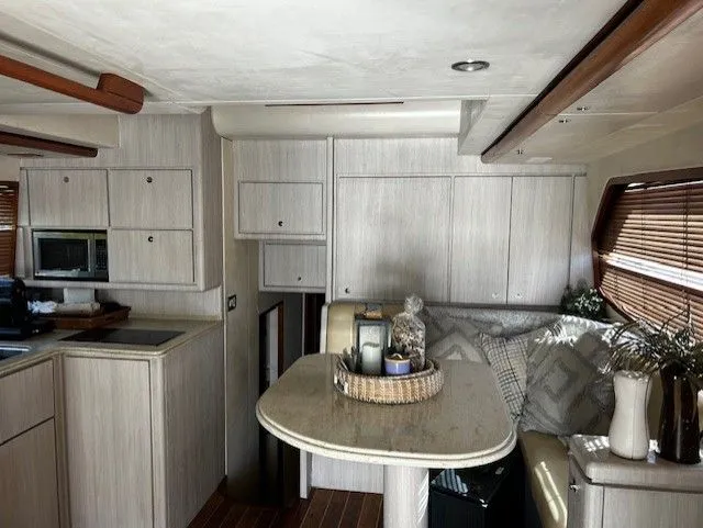  Yacht Photos Pics Interior of a 2008 Bertram 45C yacht, featuring modern kitchen and cozy seating area.