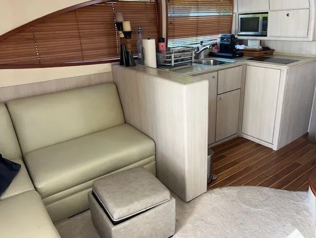  Yacht Photos Pics Interior of a 2008 Bertram 45C yacht with kitchen and seating area.