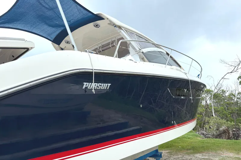  Yacht Photos Pics 2013 Pursuit 365i Sport Coupe boat with sleek design, docked outdoors.