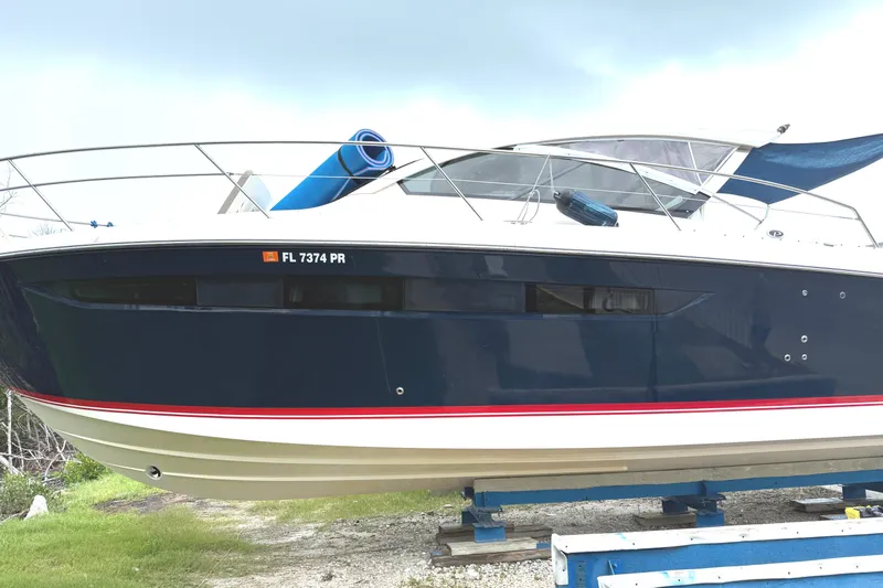  Yacht Photos Pics 2013 Pursuit 365i Sport Coupe boat on display, featuring sleek design and blue hull.