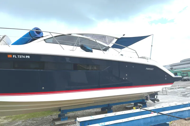  Yacht Photos Pics 2013 Pursuit 365i Sport Coupe boat on trailer, side view.