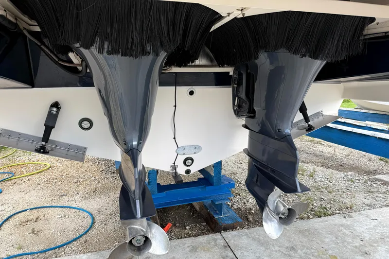  Yacht Photos Pics 2013 Pursuit 365i Sport Coupe boat with dual outboard motors on a stand.