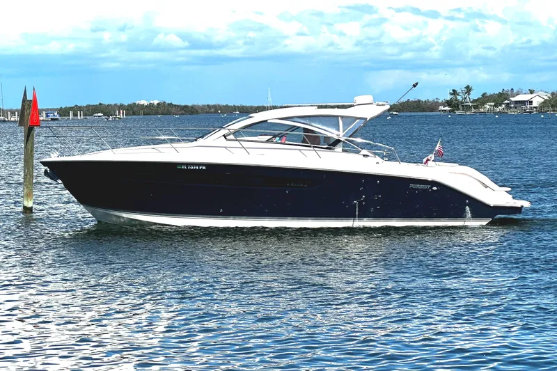  Yacht Photos Pics 2013 Pursuit 365i Sport Coupe boat on calm water under blue sky.