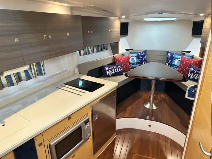  Yacht Photos Pics 2013 Pursuit 365i Sport Coupe interior with modern kitchen and cozy dining area.