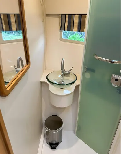  Yacht Photos Pics Compact bathroom in 2013 Pursuit 365i Sport Coupe with glass sink and modern fixtures.