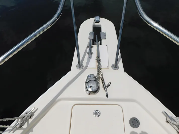 Calm Yacht Photos Pics Bow of 2005 Mainship 34 Rum Runner with anchor chain and railing.