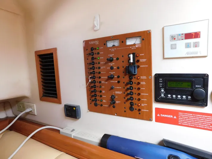 Calm Yacht Photos Pics Electrical control panel inside 2005 Mainship 34 Rum Runner boat cabin.