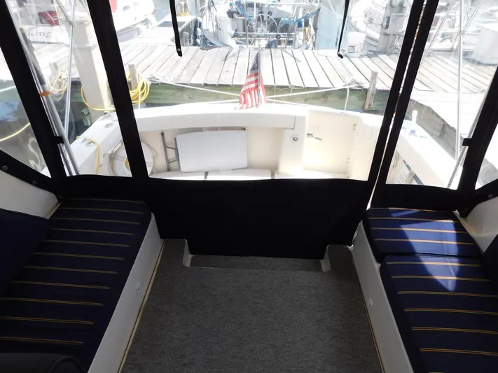 Calm Yacht Photos Pics 2005 Mainship 34 Rum Runner interior with seating and dock view.