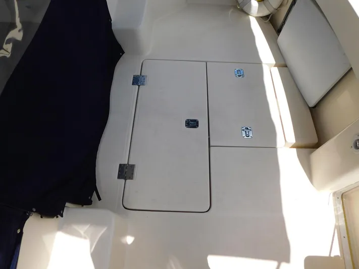 Calm Yacht Photos Pics 2005 Mainship 34 Rum Runner boat interior with storage compartments and seating area.