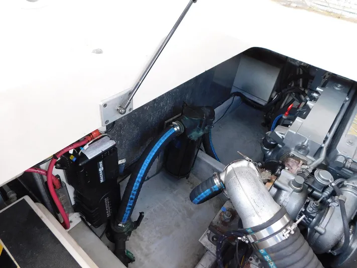 Calm Yacht Photos Pics Engine compartment of a 2005 Mainship 34 Rum Runner, showcasing mechanical components and wiring.