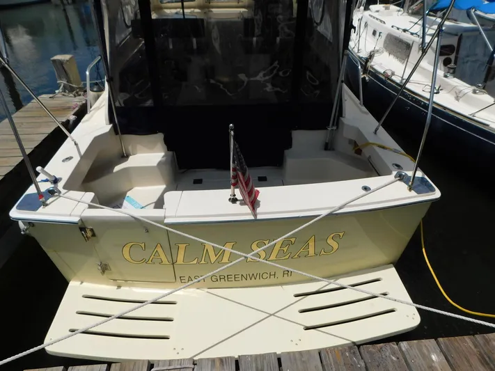 Calm Yacht Photos Pics 2005 Mainship 34 Rum Runner boat named "Calm Seas" docked at a marina.