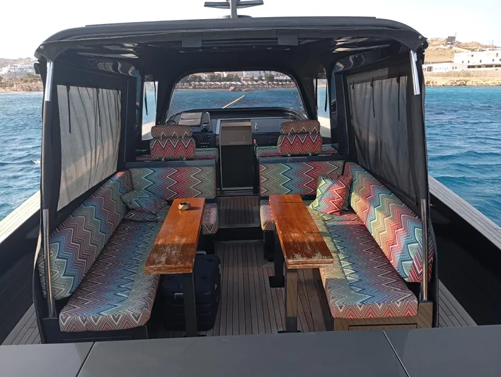  Yacht Photos Pics Luxurious Alen 55 yacht interior with colorful seating, wooden tables, and ocean view, 2016 model.