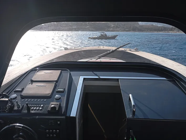  Yacht Photos Pics View from Alen 55 yacht cockpit, overlooking the sea with another boat in the distance.