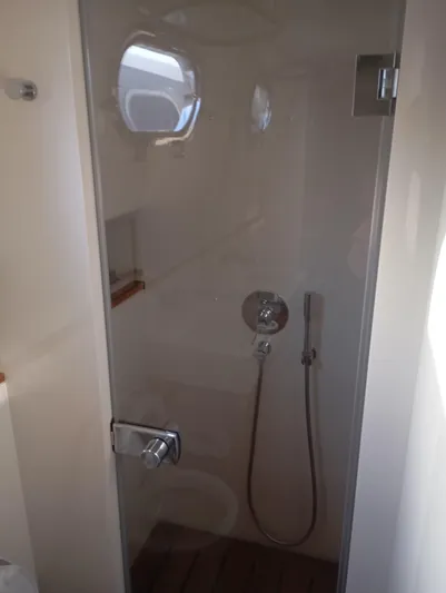  Yacht Photos Pics Shower area inside 2016 Alen 55 yacht, featuring glass door and modern fixtures.