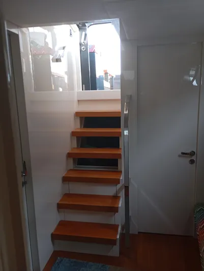  Yacht Photos Pics Wooden stairs inside Alen 55 yacht, 2016 model, leading to upper deck.