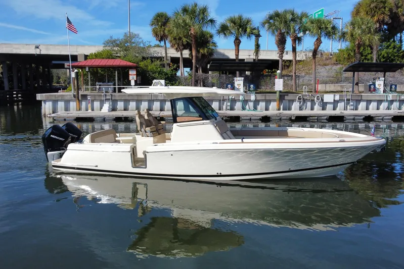  Yacht Photos Pics 2022 Chris-Craft Catalina 30 boat docked near palm trees and marina.
