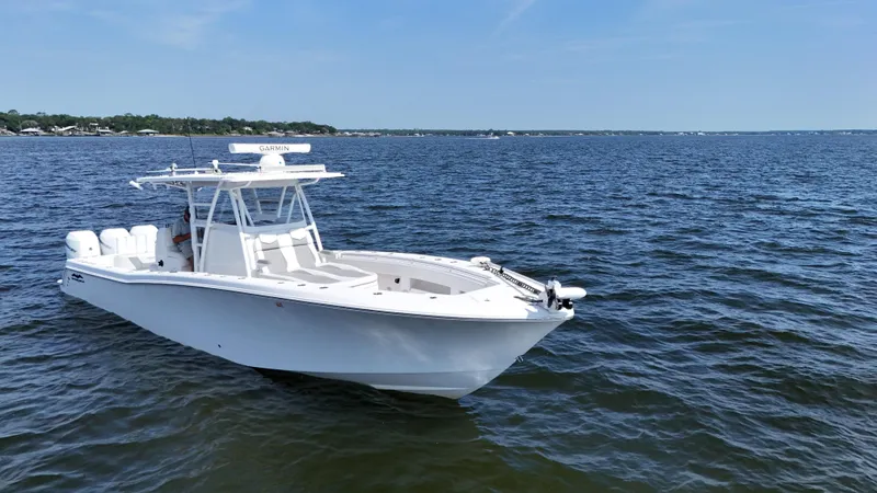  Yacht Photos Pics 2022 Invincible 36 Open Fisherman boat on calm blue water under clear sky.