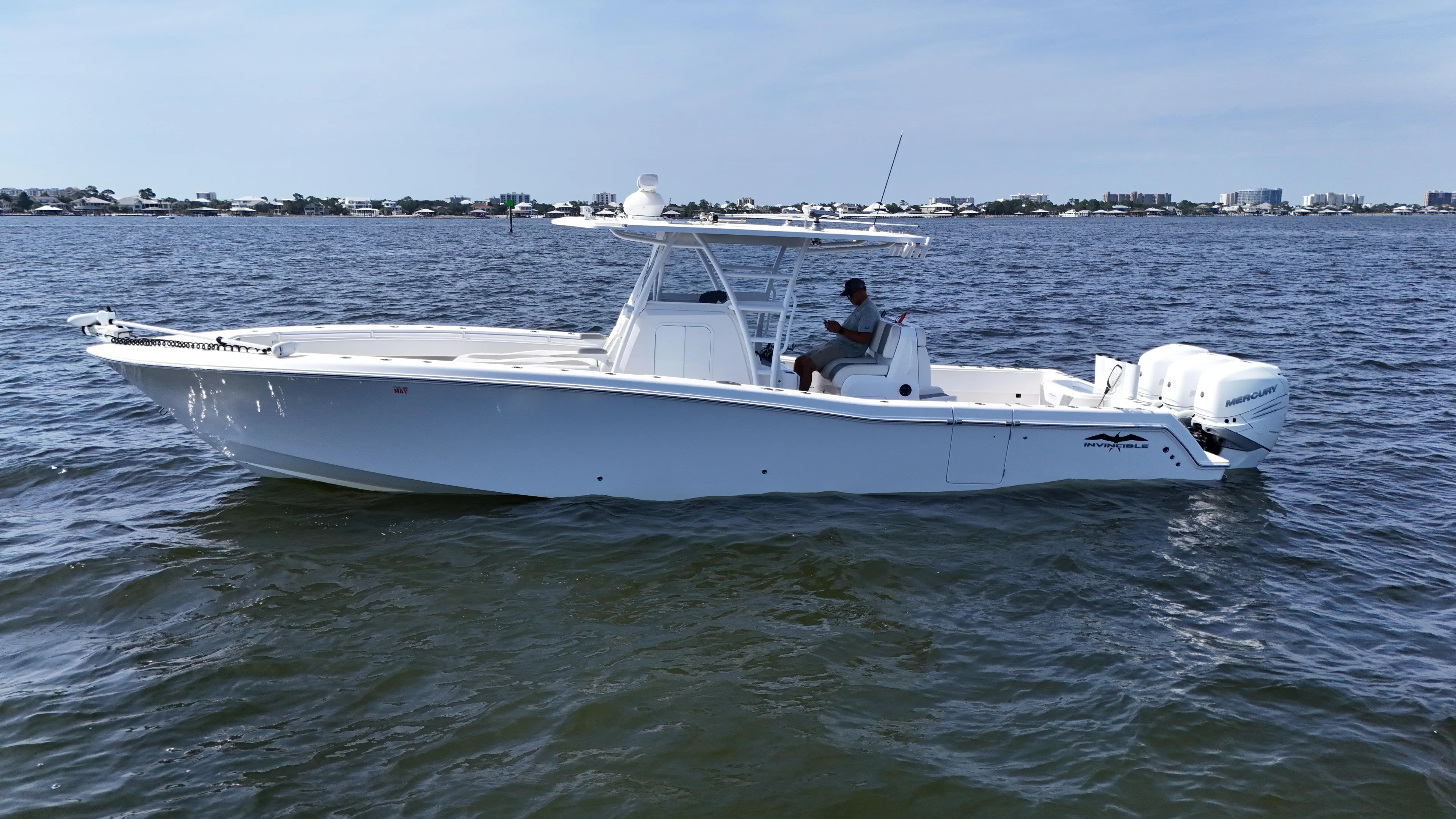  Yacht Photos Pics 2022 Invincible 36 Open Fisherman boat on calm water, side view.