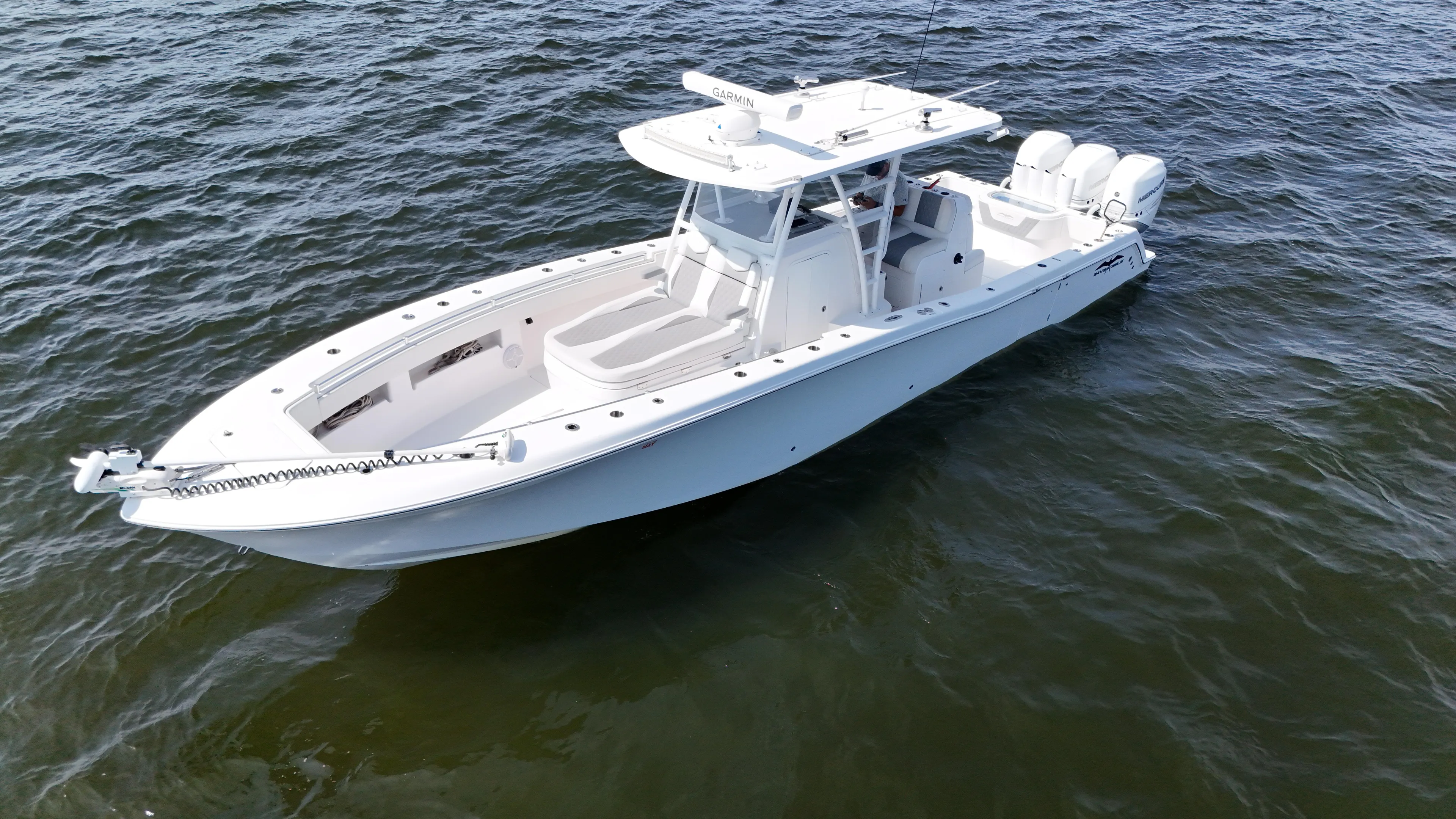  Yacht Photos Pics 2022 Invincible 36 Open Fisherman boat on open water, featuring sleek design and triple engines.