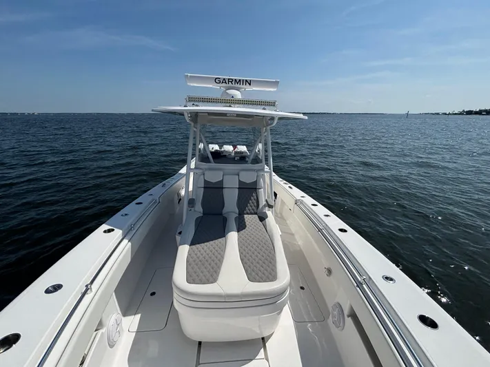  Yacht Photos Pics 2022 Invincible 36 Open Fisherman boat on calm ocean waters under clear blue sky.