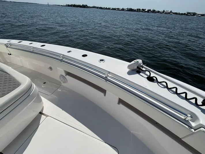  Yacht Photos Pics 2022 Invincible 36 Open Fisherman boat on calm water, showcasing sleek design and spacious deck.