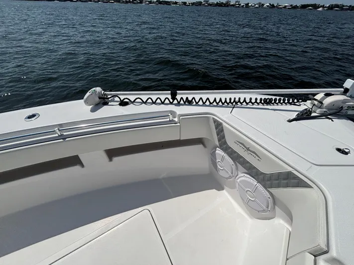  Yacht Photos Pics 2022 Invincible 36 Open Fisherman boat on water, featuring deck speakers and railing.