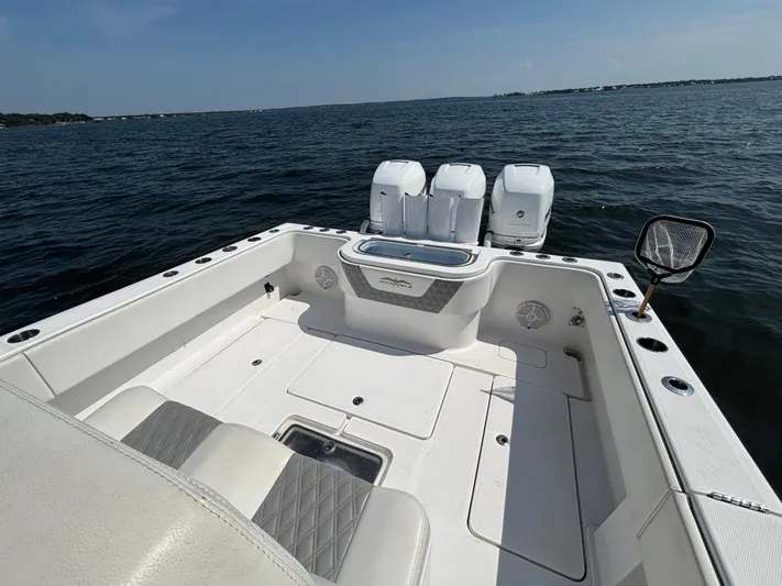  Yacht Photos Pics 2022 Invincible 36 Open Fisherman boat on water, featuring spacious deck and triple engines.