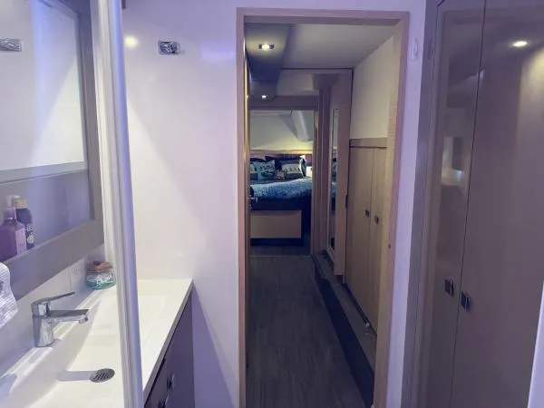 The Flying Tortuga Yacht Photos Pics Interior view of 2018 Fountaine Pajot Lucia 40 catamaran, featuring hallway and bedroom.