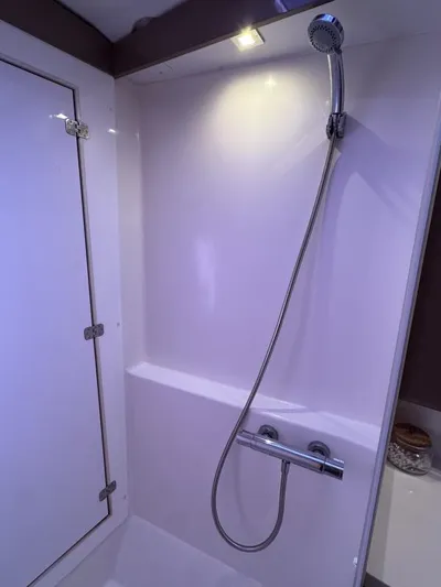 The Flying Tortuga Yacht Photos Pics Shower area in 2018 Fountaine Pajot Lucia 40 catamaran, featuring modern fixtures and lighting.
