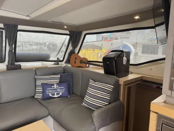 The Flying Tortuga Yacht Photos Pics Interior of 2018 Fountaine Pajot Lucia 40 catamaran with cozy seating and nautical decor.